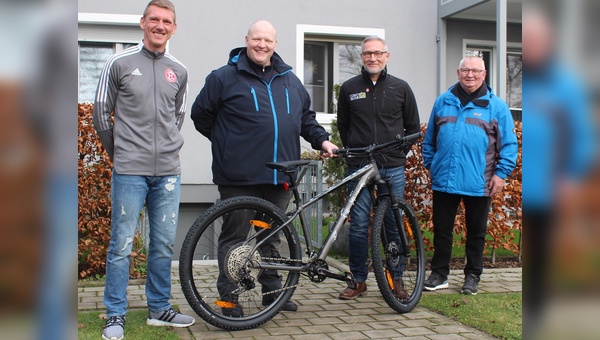 Vereinslegende Axel Bellinghausen, Gewinner Robert L., Joe Gerhards von Lucky Bike und der Vater des Gewinners bei der Übergabe des Rades.