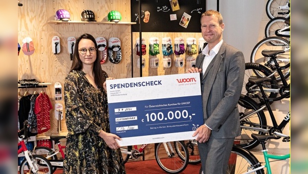 woom Projektmanagerin Marlene Fussi und Christoph Juenger, Geschäftsfuehrer des Oesterreichischen Komitees für UNICEF, bei der Uebergabe des Spendenschecks über 100.000 Euro.